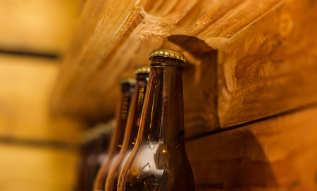 Close up of bottles of craft beer on wooden backgroundの写真素材