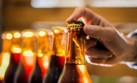 Wet bottles of craft beer on blurred backgroundの写真素材