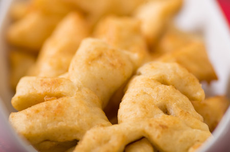 Closeup of delicious ecuadorian pristinos, piled up fresh from the fryer, traditional andean pastry...