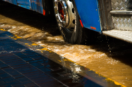 QUITO, ECUADOR - SEPTEMBER 20, 2016: Close up of a bus rides on a flooded road in Quito city after a heavy rainのeditorial素材