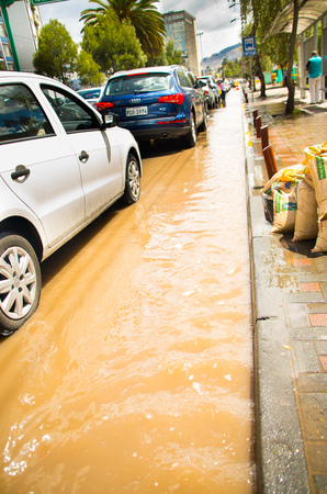 QUITO, ECUADOR - SEPTEMBER 20, 2016: Car rides on a flooded road in Quito city after a heavy rainのeditorial素材