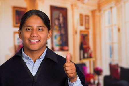 Close up portrait of young indigenous man wearing traditional clothes from the highlands in Ecuadorの写真素材