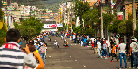 Quito, Ecuador - May 06, 2017: An unidentified people watching a racing wooden car in an urban road inside of the streets of city of Quitoのeditorial素材