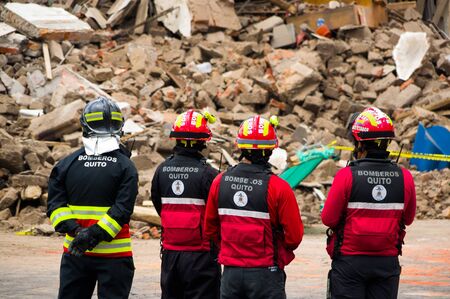 Quito, Ecuador - December 09, 2016: An unidentified group of firemans watching the damage and destruction in building After Fire Infernoのeditorial素材