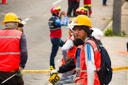 Quito, Ecuador - December 09, 2016: An unidentifiedgroup of happy firefighters team with equipment, helmet, worker glasses and mask, in streetsのeditorial素材