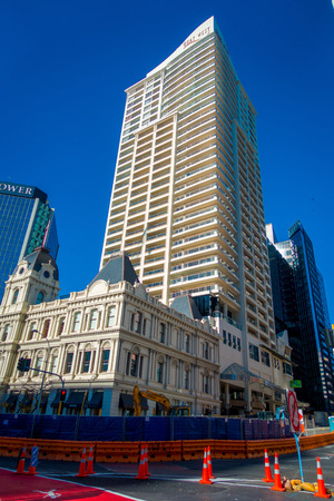 AUCKLAND, NEW ZEALAND- MAY 12, 2017: Beautiful apartment building in front of HSBC office building with Sky Towerのeditorial素材
