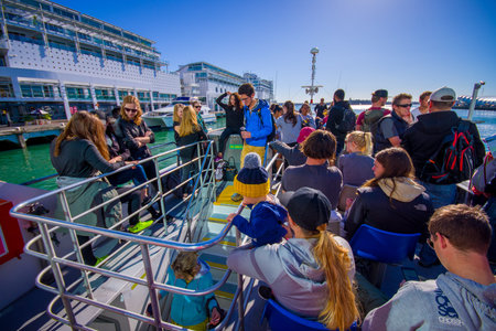 AUCKLAND, NEW ZEALAND- MAY 12, 2017: Unidentified people on a cruise looking at Auckland waterfront...
