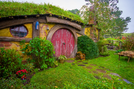 NORTH ISLAND, NEW ZEALAND- MAY 16, 2017: Hobbit house with red door, hobbiton movie set, site made for movies: Hobbit and Lord of the ring in Matamata, north island of New Zealand