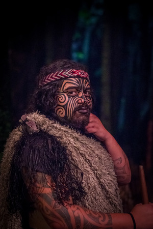 NORTH ISLAND, NEW ZEALAND- MAY 17, 2017: Close up of a Tamaki Maori leader man with traditionally tatooed face in traditional dress at Maori Culture, Tamaki Cultural Village, Rotorua, New Zealandのeditorial素材