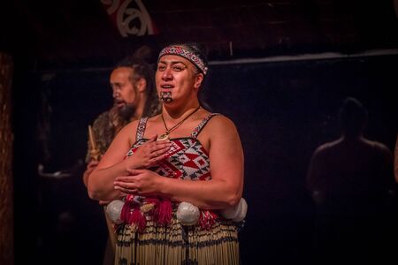 NORTH ISLAND, NEW ZEALAND- MAY 17, 2017: Close up of a Tamaki Maori woman with traditionally tatooed face and wearing traditional dress at Maori Culture village in Tamaki Cultural Village, Rotorua, New Zealandのeditorial素材