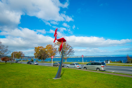 NORTH ISLAND, NEW ZEALAND- MAY 18, 2017: Some cars parked in the street, and beautiful view of Lake Taupo with mountains in the background at spring, North Island of New Zealand with beautiful blue skyのeditorial素材