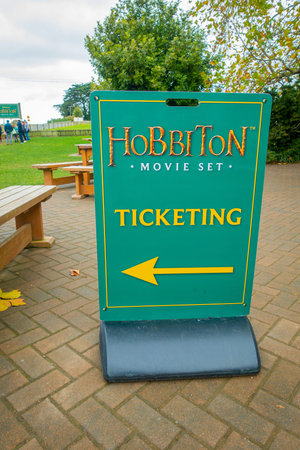 NORTH ISLAND, NEW ZEALAND- MAY 16, 2017: Welcoming board by the entrance to Hobbiton Village at...