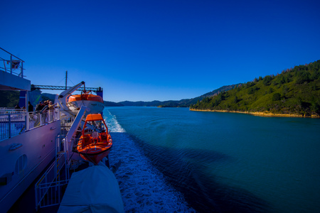 SOUTH ISLAND, NEW ZEALAND- MAY 25, 2017: Unidentified people enjoying the beautiful view from South island to North island at ferry, some orange boats on one side of the ferry, in New Zealandのeditorial素材