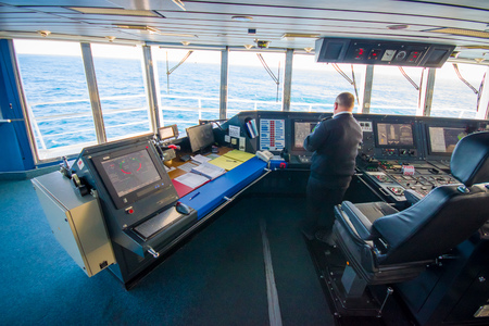 SOUTH ISLAND, NEW ZEALAND- MAY 25, 2017: Ferry boat pilot command cabin with the captain operating the machines with a beautiful view on the sea, in new zealandのeditorial素材