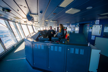 SOUTH ISLAND, NEW ZEALAND- MAY 25, 2017: Ferry boat pilot command cabin with the captain operating the machines with a beautiful assistant looking a beautiful view on the sea, in new zealandのeditorial素材