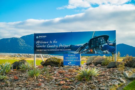 SOUTH ISLAND, NEW ZEALAND- MAY 23, 2017: Informative sign of glacier country heliport located in South Island in New Zealandのeditorial素材