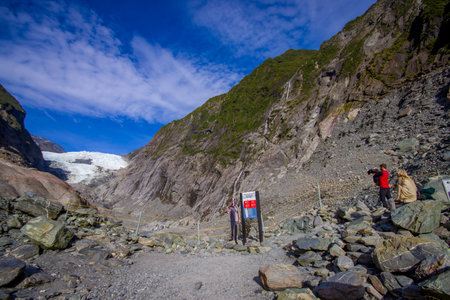 SOUTH ISLAND, NEW ZEALAND- MAY 25, 2017: Unidentified people hiking the Franz Josef Glacier and valley floor, Westland, South Island, New Zealandのeditorial素材