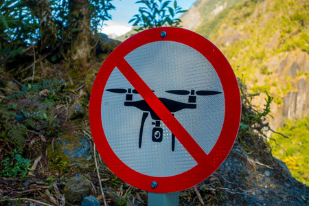SOUTH ISLAND, NEW ZEALAND- MAY 25, 2017: An informative sign of do not allow use drones danger in a beautiful landscape of Franz Josef Glacier National Park, in New Zealandのeditorial素材