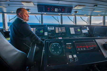 SOUTH ISLAND, NEW ZEALAND- MAY 25, 2017: Close up of a ferry boat pilot command cabin with the captain operating the machines with a beautiful view on the sea, in new zealandのeditorial素材