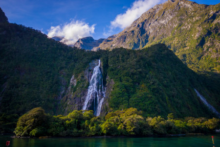 Landscape of high mountain glacier at milford sound with a beautiful lake and waterfall, in south island in New Zealandの写真素材