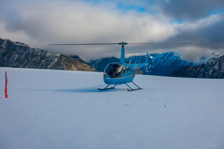 SOUTH ISLAND, NEW ZEALAND- MAY 24, 2017: Close up of blue helicopter waiting over the snow for hunters in South Westlands Southern Alps, New Zealandのeditorial素材