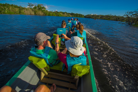 CUYABENO, ECUADOR - NOVEMBER 16, 2016: Unidentified people travelling by boat into the depth of Amazon Jungle in Cuyabeno National Park, Ecuadorのeditorial素材