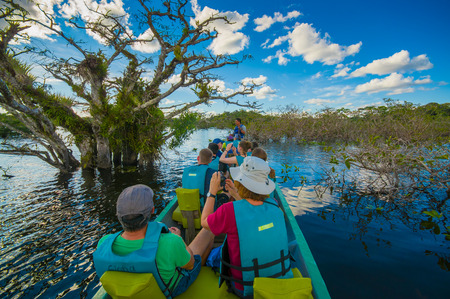 CUYABENO, ECUADOR - NOVEMBER 16, 2016: Unidentified people travelling by boat into the depth of Amazon Jungle in Cuyabeno National Park, Ecuadorのeditorial素材