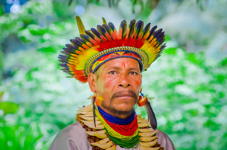LAGO AGRIO, ECUADOR - NOVEMBER 17, 2016: Portrait of a Siona shaman in traditional dress with a feather hat in an indigenous village in the Cuyabeno Wildlife Reserveのeditorial素材