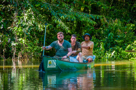 CUYABENO, ECUADOR - NOVEMBER 16, 2016: Unidentified people travelling by boat into the depth of Amazon Jungle in Cuyabeno National Park, Ecuadorのeditorial素材