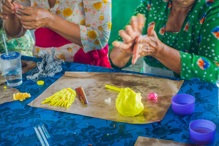 BALI, INDONESIA - MARCH 08, 2017: Women preparing an Indian Sadhu dough for chapati on Manmandir ghat on the banks of the holy river Ganges in Varanasiのeditorial素材