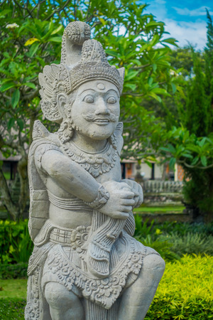 BALI, INDONESIA - MARCH 08, 2017: Beautiful stone statue inside of the Royal temple of Mengwi Empire located in Mengwi in Bali, Indonesiaのeditorial素材