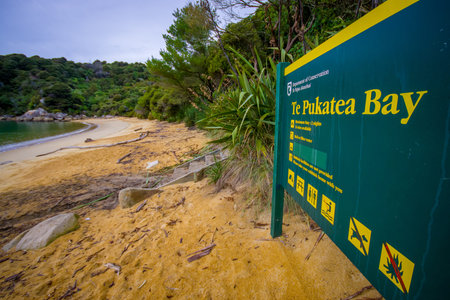 SOUTH ISLAND, NEW ZEALAND- MAY 22, 2017: Informative sign in the beach in Abel Tasman National Park located in South Island in New Zealandのeditorial素材