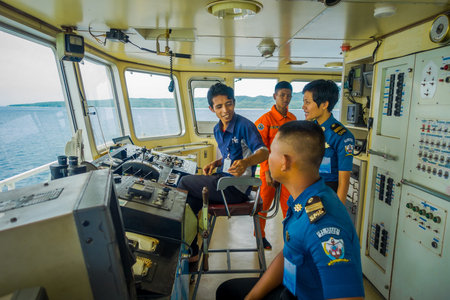BALI, INDONESIA - APRIL 05, 2017: Ferry boat pilot command cabin with view on the sea with many...