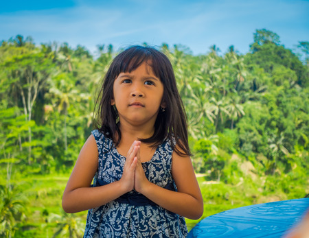 BALI, INDONESIA - APRIL 05, 2017: Two beautiful girls wearing a dress in a sunny day, in Ubud Indonesiaのeditorial素材