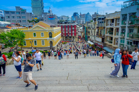 MACAU, CHINA- MAY 11, 2017: An unidentified people taking pictures about the beautiful city of Macau, behind the buildings the iconic hotel Grand Lisboa is a very big hotel and restaurant, also the oldest casino in Macau cityのeditorial素材