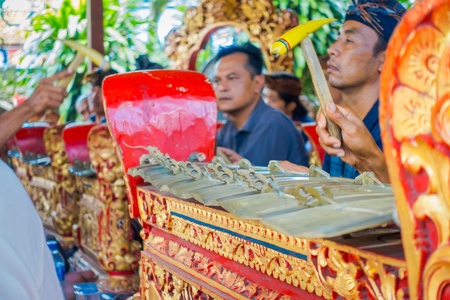 BALI, INDONESIA - APRIL 05, 2017:Unidentified people playing some musical instruments inside of a building in the beautiful temple in Ubud Bali located in Indonesiaのeditorial素材
