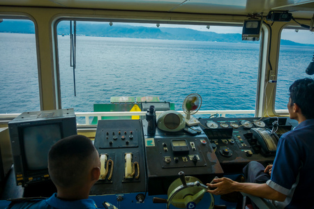 BALI, INDONESIA - APRIL 05, 2017: Ferry boat pilot command cabin with view on the sea with many assistants there in Ubud, Bali Indonesiaのeditorial素材