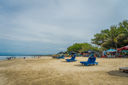 BALI- INDONESIA MARCH 08 2017: Late Afternoon at Low Tide tourists strolling on Legian Beachのeditorial素材
