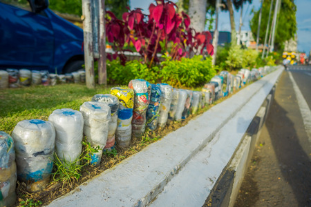 BALI, INDONESIA - MARCH 08, 2017: A plastic water bottles in the park at upside down in row, recycled to adorn parks and avenues, the concept of environmental protection in Denpasar Indonesiaのeditorial素材