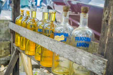BALI, INDONESIA - MARCH 08, 2017: Illegal gasoline petrol is sold at the side of the road, recycled glass vodka bottles in Bali, Indonesiaのeditorial素材