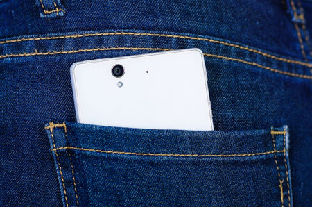 White cellphone inside of jeans back pocketの写真素材