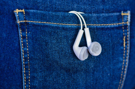 White headphones inside of jeans back pocket