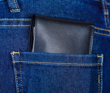 Black wallet inside of jeans back pocketの写真素材