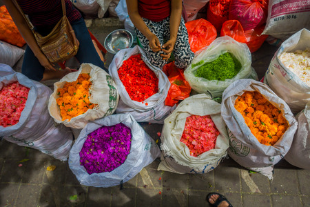 BALI, INDONESIA - MARCH 08, 2017: Outdoor Bali flower market. Flowers are used daily by Balinese Hindus as symbolic offerings at temples, inside of colorful basketsのeditorial素材
