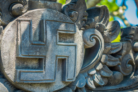 BALI, INDONESIA - MARCH 08, 2017: Nazi symbol carving over a wall concrete, that represent Hitler government, located in the city of Densapar in Bali Indonesiaのeditorial素材