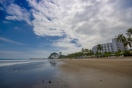 Beautiful view of the beach with sand, and buildings behind in a beautiful day in with sunny weather in a blue sky in Same, Ecuadorの写真素材