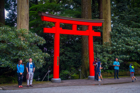HAKONE, JAPAN - JULY 02, 2017: Unidentified people drinking water at the enter of red Tori Gate at...
