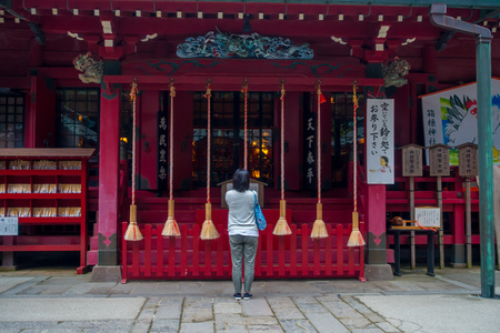 HAKONE, JAPAN - JULY 02, 2017: Unidentified woman stops to pray at Hakone shrine temple in Hakone, Japan.のeditorial素材