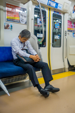 HAKONE, JAPAN - JULY 02, 2017: Unidentified man sleeping at the interior of train during rainy and cloudy day.のeditorial素材