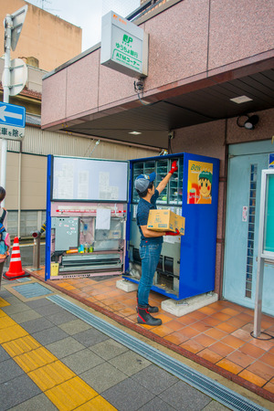 KYOTO, JAPAN - JULY 05, 2017: Unidentified man filling with products the juice machine in Kyoto, Japan. Arashiyama is a district on the western outskirts of Kyotoのeditorial素材
